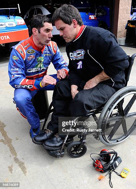 Max Papis, driver of the Geico Toyota speaks with his crew chief Bootie Barker in the garage during practice for the NASCAR Sprint Cup Series Auto...