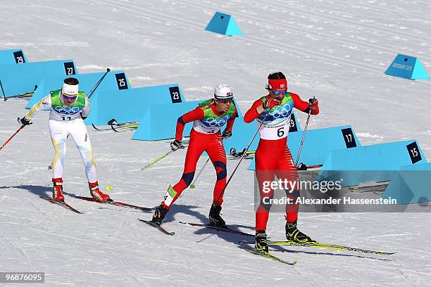 Marit Bjoergen of Norway skies in the lead ahead of Kristin Stoermer Steira of Norway and Anna Haag of Sweden during the Ladies' 15 km Pursuit on day...