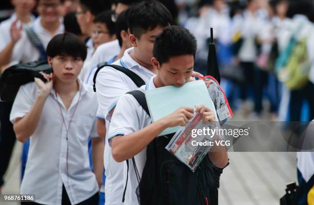 Candidates enter an exam site for the National College Entrance Examination at Haikou No.1 High School on June 7, 2018 in Haikou, Hainan Province of...