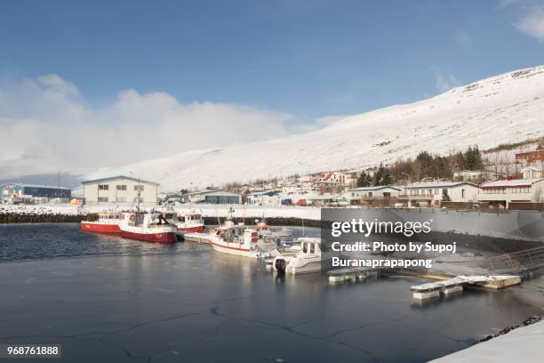 eskifjordur,iceland - march 07,2018 : harbor of eskifjordur in east iceland with snow-capped mountains in the background - ship propeller stock pictures, royalty-free photos & images