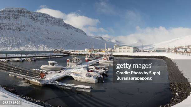 eskifjordur,iceland - march 07,2018 : harbor of eskifjordur in east iceland with snow-capped mountains in the background - ship propeller stock pictures, royalty-free photos & images