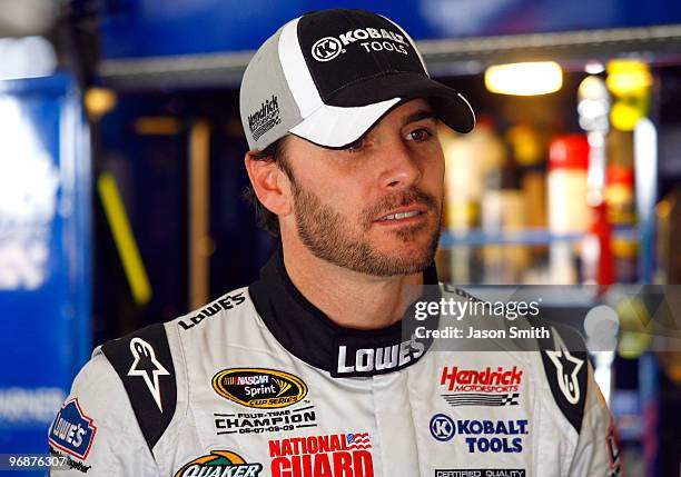 Jimmie Johnson driver of the Lowe's/Kobalt Tools Chevrolet, stands in the garage during practice for the NASCAR Sprint Cup Series Auto Club 500 at...