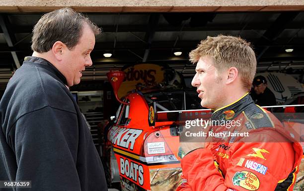 Crew Chief Kevin Manion of the Bass Pro Shops Chevrolet speaks with his driver Jamie McMurray in the garage area during practice for the NASCAR...