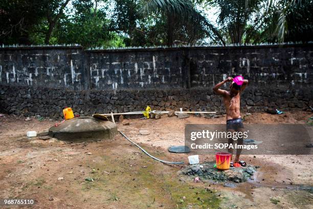 Boy taking a bath at the surf camp. In Bureh Beach, 70 kilometers from Freetown, there is a surfing camp, where the kids forget the daily miseries...