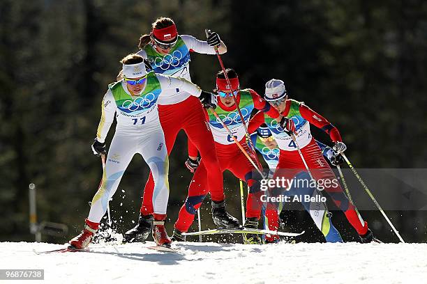 Anna Haag of Sweden leads in the Ladies' 15 km Pursuit as Justyna Kowalczyk of Poland and the eventually winner, Marit Bjoergen of Norway pursue...