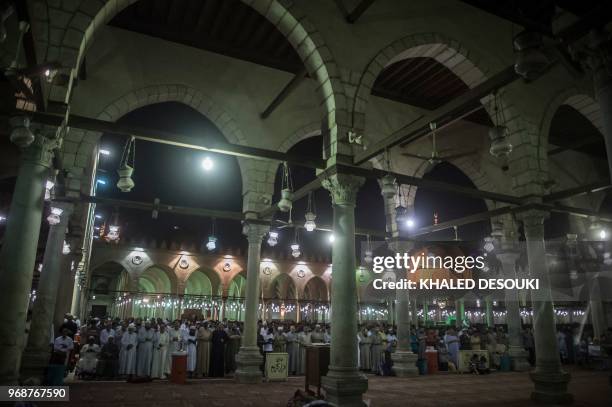 Egyptians chant the Tarawih recitations on the occasion of Laylat al-Qadr during the fasting month of Ramadan at Cairo's historic mosque of Amr Ibn...