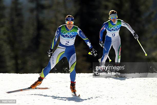 Aino-Kaisa Saarinen of Finland and Marianna Longa of Italy during the Ladies' 15 km Pursuit race on day 8 of the 2010 Vancouver Winter Olympics at...