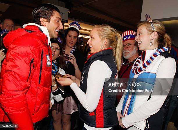 Evan Lysacek of the United States shares his men's figure skating Olympic gold medal with U.S. Gymnast Nastia Liukin at the USA House on February 18,...