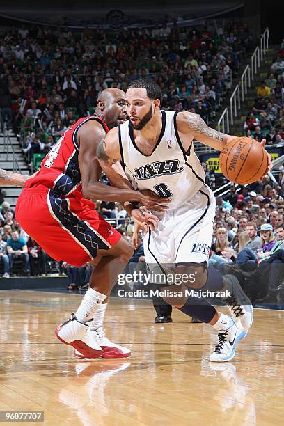 Deron Williams of the Utah Jazz moves the ball against Trenton Hassell of the New Jersey Nets during the game at EnergySolutions Arena on January 23,...