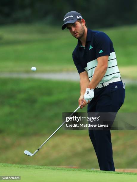 Bradley Neil of Scotland chips onto the 17th green during day one of the 2018 Shot Clock Masters at Diamond Country Club on June 7, 2018 in...
