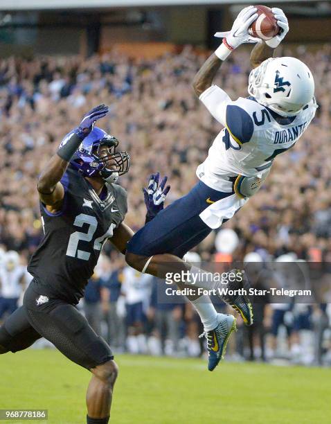 West Virginia wide receiver Jovon Durante can't bring in a first-quarter pass as TCU cornerback Julius Lewis defends at Amon G. Carter Stadium in...