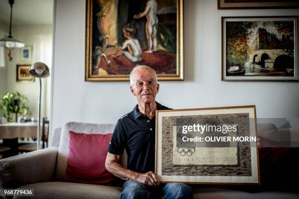 Former Finnish Olympic gymnastics athlete in Rome and Tokyo , Kauko Heikkinen poses with his participation diploma at the 1960 Rome Olympic Games, at...