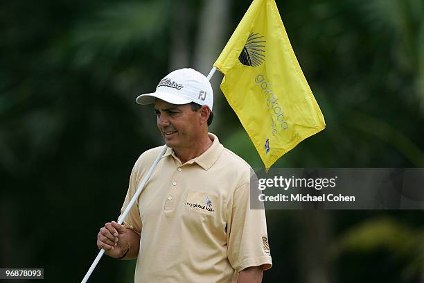 Tom Pernice, Jr. Holds a flagstick during the second round of the Mayakoba Golf Classic at El Camaleon Golf Club held on February 19, 2010 in Riviera...