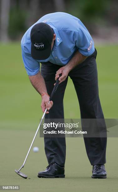 Chris Smith coaxes an insect from his putting line during the second round of the Mayakoba Golf Classic at El Camaleon Golf Club held on February 19,...