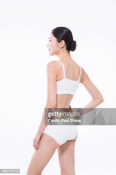 portrait of smiling young chinese woman - camisole stockfoto's en -beelden