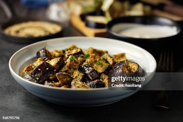 roasted aubergine cubes with sesame seeds - haoliang stock pictures, royalty-free photos & images