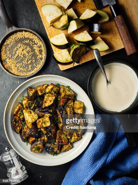 roasted aubergine cubes with sesame seeds - tahini stock pictures, royalty-free photos & images