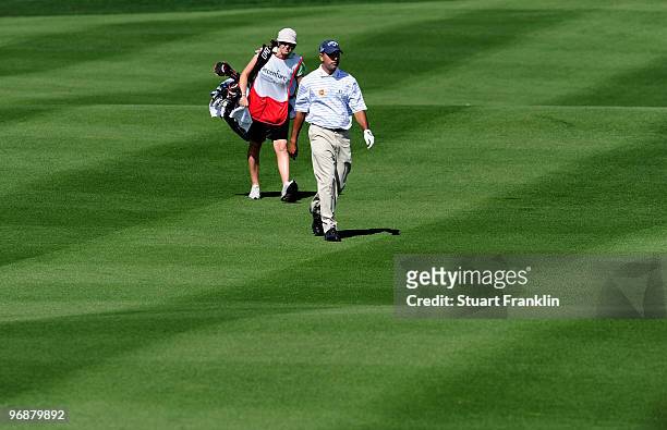 Jeev Milkha Singh of India and caddie Janet Squire walk on the fifth hole during round three of the Accenture Match Play Championship at the...