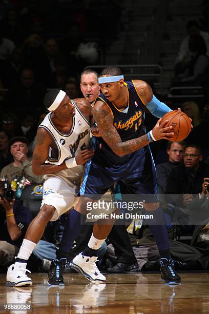 Carmelo Anthony of the Denver Nuggets holds the ball against Josh Howard of the Washington Wizards at the Verizon Center on February 19, 2010 in...