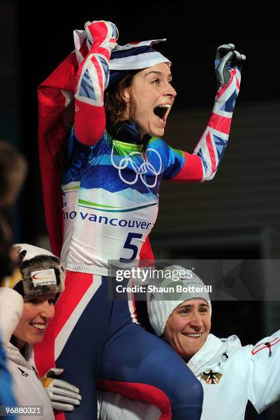 Amy Williams of Great Britain and Northern Ireland celebrates with her countries flag after she completed her run to win the gold medal in the...