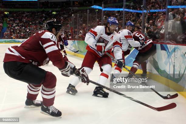 Girts Ankipans of Latvia challenges Jaromir Jagr of Czech Republic for the puck during the ice hockey men's preliminary game between Czech Republic...