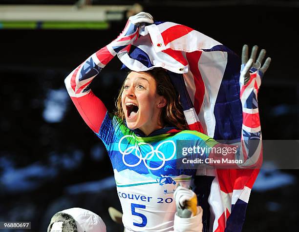 Amy Williams of Great Britain and Northern Ireland celebrates with her countries flag after she completed her run to win the gold medal in the...