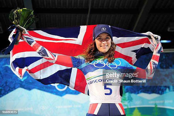 Amy Williams of Great Britain and Northern Ireland celebrates with her countries flag after winning the gold medal during the flower cermony for the...