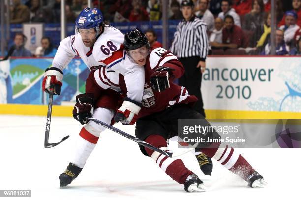 Martins Cipulis of Latvia tangles with Jaromir Jagr of Czech Republic during the ice hockey men's preliminary game between Czech Republic and Latvia...