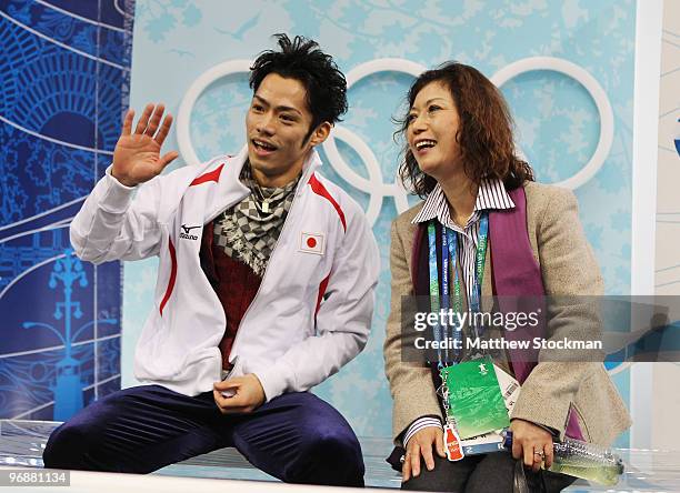 Bronze medalist Daisuke Takahashi of Japan is seen in the kiss and cry area with his coach Utako Nagamitsu during the men's figure skating free...