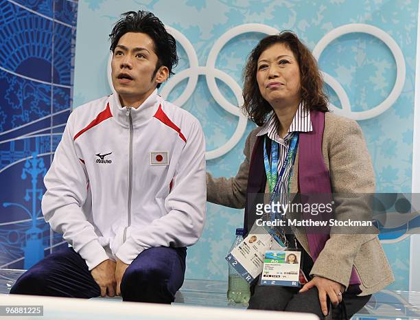 Bronze medalist Daisuke Takahashi of Japan is seen in the kiss and cry area with his coach Utako Nagamitsu during the men's figure skating free...