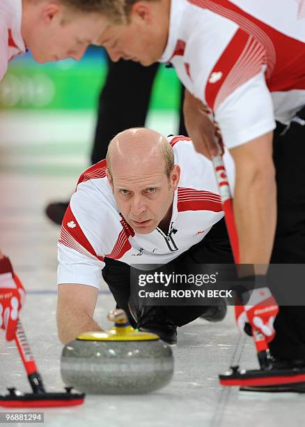 Canada's skip Kevin Martin throws a stone during the men's curling round robin match against Denmark at the Vancouver Olympic Centre during the...