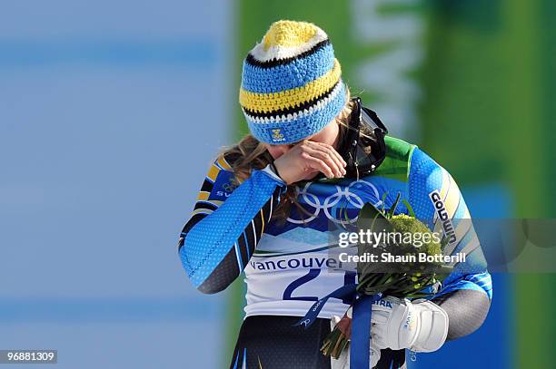 Anja Paerson of Sweden celebrates silver during the flower ceremony for the women's super combined alpine skiing on day 7 of the Vancouver 2010...