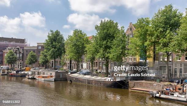House-boats are moored on the Waalseilandsgracht Canal on May 30, 2018 in Amsterdam, Netherlands. House-boats of Amsterdam are provided with all...