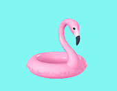Inflatable flamingo isolated on turquoise background