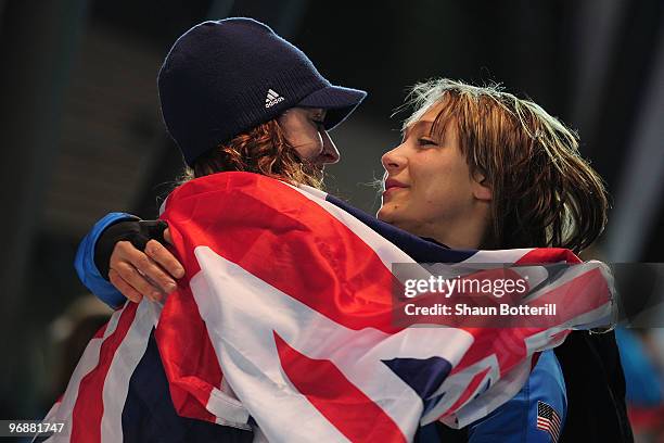 Amy Williams of Great Britain and Northern Ireland is congratulated by Katie Uhlaender of the United States after Williams won the gold medal in the...