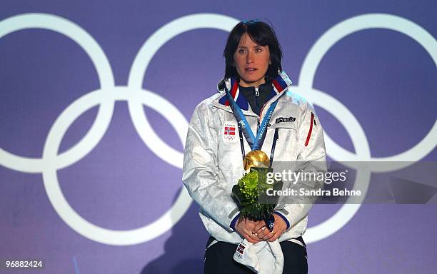 Marit Bjoergen of Norway celebrates gold during the medal ceremony for the women's biathalon 15 km pursuit on day 8 of the Vancouver 2010 Winter...