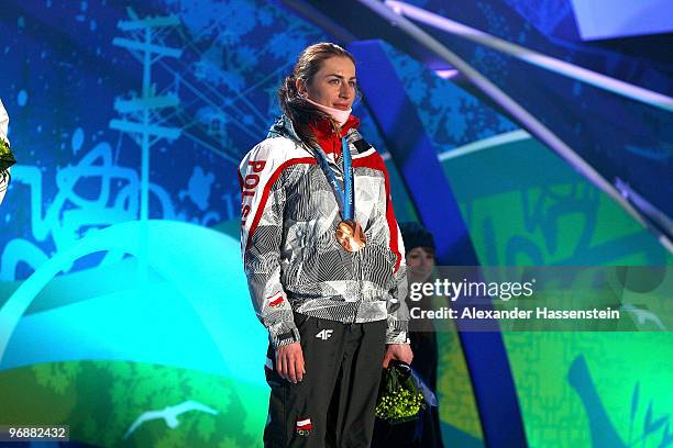 Justyna Kowalczyk of Poland celebrates bronze during the medal ceremony for the women's biathalon 15 km pursuit on day 8 of the Vancouver 2010 Winter...