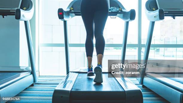 low section of woman on treadmill - lower stock pictures, royalty-free photos & images