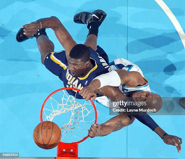 David West of the New Orleans Hornets fights for the ball against Roy Hibbert of the Indiana Pacers on February 19, 2010 at the New Orleans Arena in...