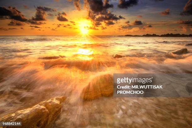 wave breaking in the sunrise - surf tube stock pictures, royalty-free photos & images