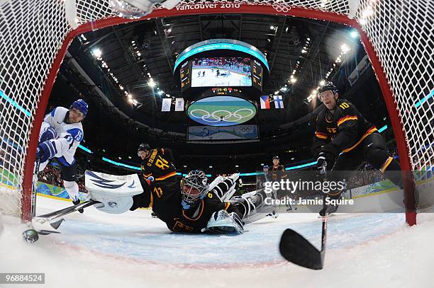 Tuomo Ruutu of Finland scores a goal against Dimitri Patzold of Germany during the ice hockey men's preliminary game between Finland and Germany on...