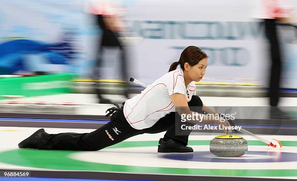 Anna Ohmiya of Japan releases a stone during the Women's Curling Round Robin match between Great Britain and Japan on day 8 of the Vancouver 2010...