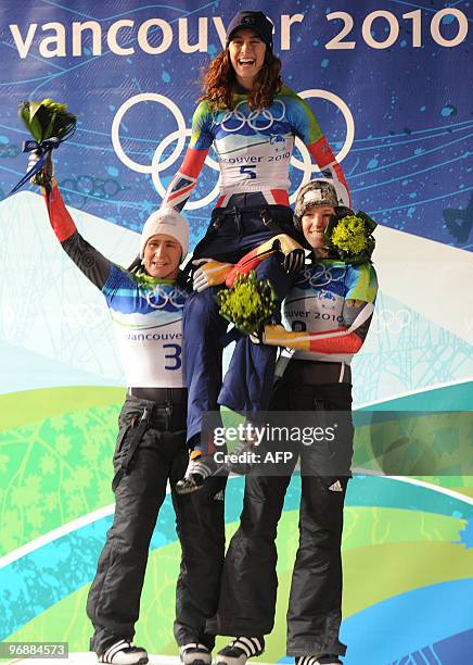 Britain's Amy Williams celebrates winning gold with silver medalist Kirstin Szymkowiak of Germany and bronze medalist Anya Huber of Germany in the...