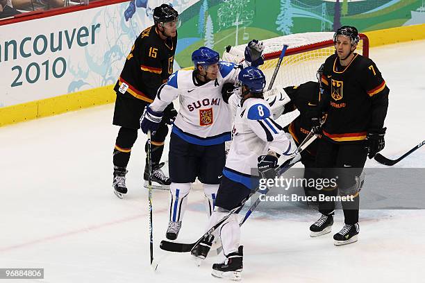 Tuomo Ruutu of Finland and his teammate Teemu Selanne of Finland celebrate his goal against Dimitri Patzold of Germany during the ice hockey men's...