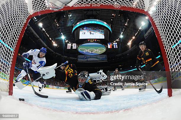 Tuomo Ruutu of Finland scores a goal against Dimitri Patzold of Germany during the ice hockey men's preliminary game between Finland and Germany on...