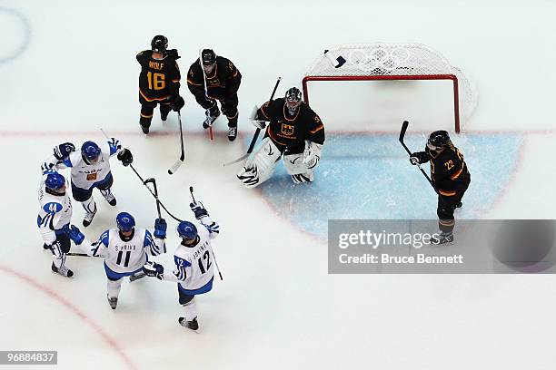 Tuomo Ruutu of Finland and his teammates celebrates his goal against Dimitri Patzold of Germany during the ice hockey men's preliminary game between...