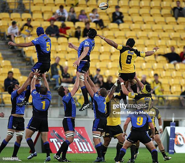 Victor Vito of the Hurricanes jumps for the lineout ball with Tom Hockings and Nathan Sharpe of the Force during the round two Super 14 match between...