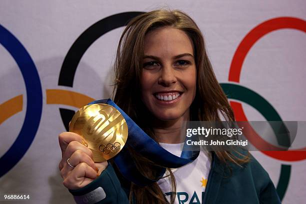Snowboarder Torah Bright of Australia celebrates her gold medal win in the women's halfpipe at the Sheraton Wall Centre during the Olympic Winter...