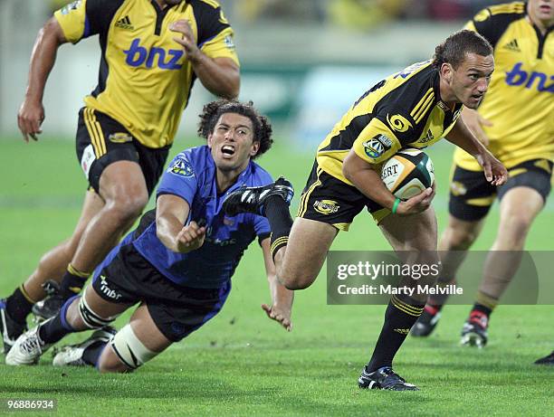 Aaron Cruden of the Hurricanes is tackled by Sam Wykes of the Force during the round two Super 14 match between the Hurricanes and the Western Force...