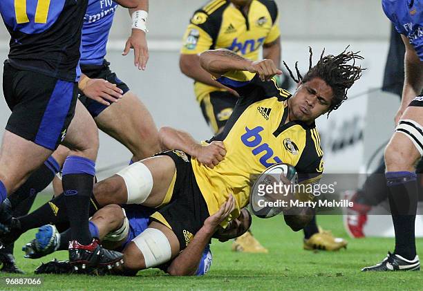 Rodney So'oialo of the Hurricanes is tackled by Matt Hodgson of the Force during the round two Super 14 match between the Hurricanes and the Western...